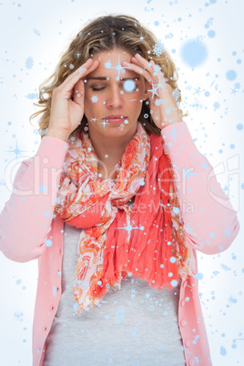 Composite image of blonde girl touching her temples because of a headache