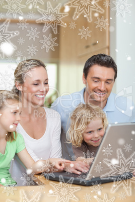 Family using laptop in the kitchen