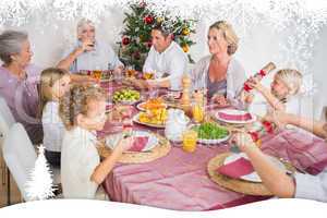 Composite image of family having christmas dinner