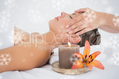 Attractive woman receiving head massage at spa center