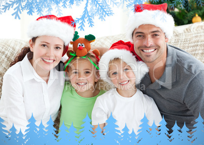 Happy family with christmas hats sitting on the sofa