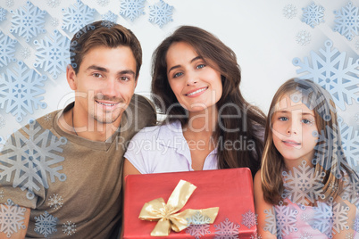 Composite image of father and his daughter offering a gift to he