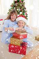 Composite image of happy brother and sister holding christmas pr