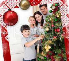 Smiling family decorating a christmas tree