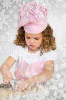 Cute little girl making biscuit at a table