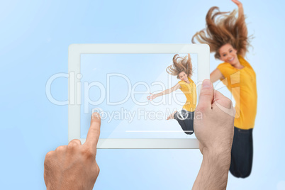 Composite image of hand holding tablet pc