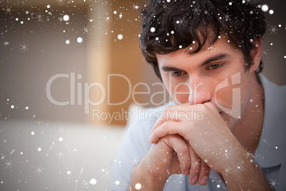 Composite image of thoughtful man in the living room