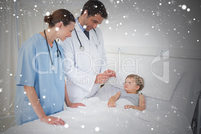 Composite image of doctors attending little girl