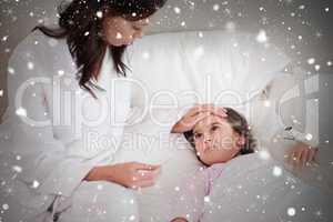 Composite image of mother checking on her daughters temperature