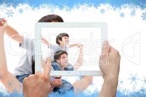 Composite image of hand holding tablet pc