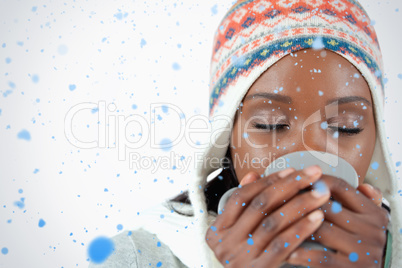 Young woman enjoying a cup of tea in the cold