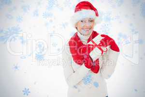 Festive woman smiling at camera holding a gift