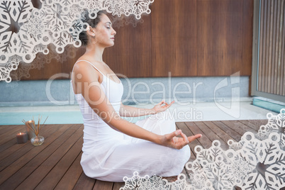 Peaceful brunette in white sitting in lotus pose