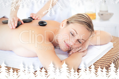 Pretty young woman receiving a massage with hot stone Pretty young woman receiving a massage with hot stone