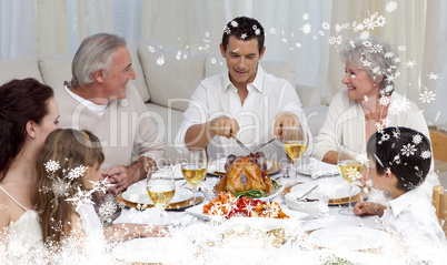 Composite image of father serving turkey to his family in a dinn