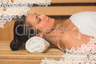 Peaceful brunette relaxing in a sauna