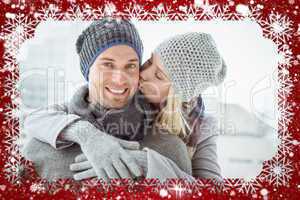 Cute couple in warm clothing hugging man smiling at camera