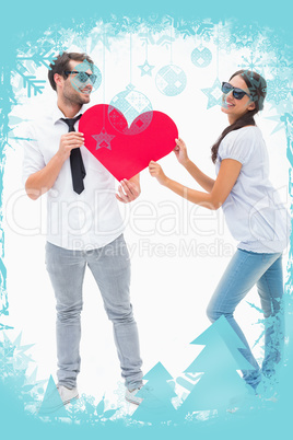 Hipster couple smiling at camera holding a heart