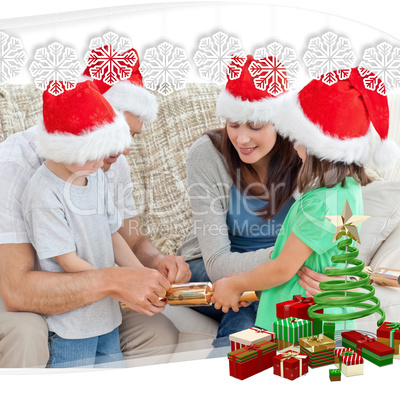 Family opening crackers together on the sofa