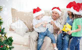 Father and son playing with a cracker on the sofa