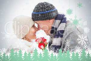 Happy mature couple in winter clothes with roses