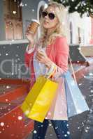 Pretty blonde holding shopping bags and coffee cup