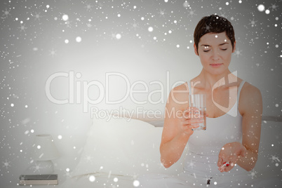 Composite image of charming woman taking pills