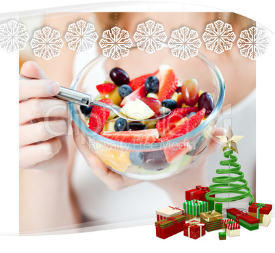 Close up of a woman eating a fruit salad