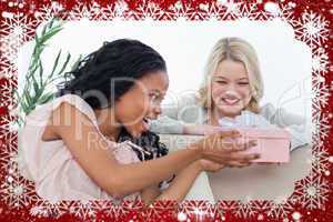 Woman giving a present in a box to her friend