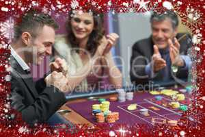 Composite image of people cheering man at craps game