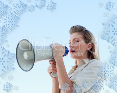 Blonde businesswoman shouting through megaphone