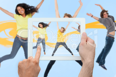 Composite image of hand holding tablet pc