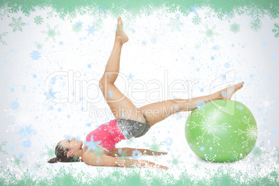 Attractive sporty brunette exercising with exercise ball