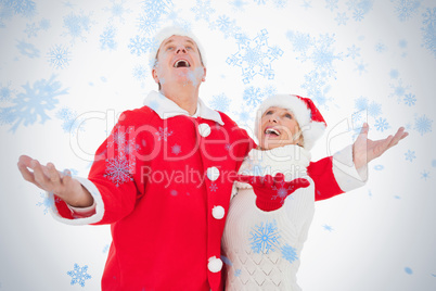 Festive couple smiling and looking up