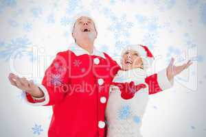 Festive couple smiling and looking up