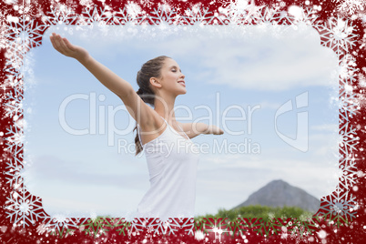 Beautiful woman with arms raised against sky