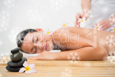 Beautiful brunette enjoying a flower back massage