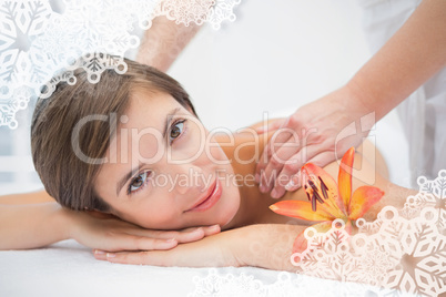 Attractive woman receiving shoulder massage at spa center