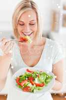 Blonde woman eating a salad
