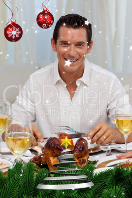 Smiling man eating turkey in christmas dinner