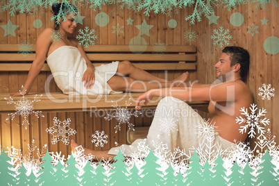 Happy couple relaxing in a sauna and chatting