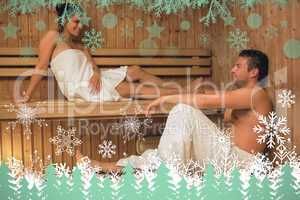 Happy couple relaxing in a sauna and chatting