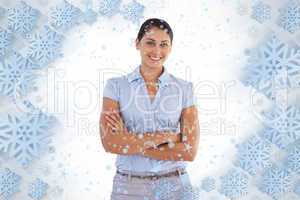 Smiling businesswoman standing alone with her arms crossed