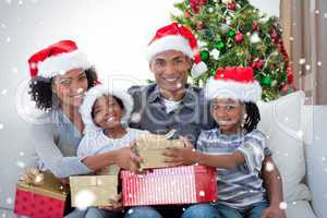 Smiling family sharing christmas presents