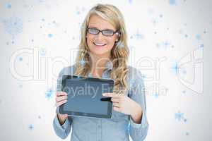 Woman wearing glasses and pointing on her tablet