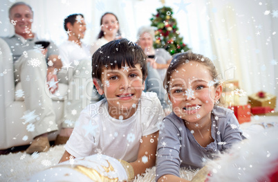 Composite image of smiling children looking for presents in chri