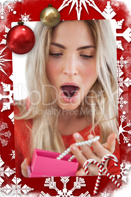Composite image of shocked woman discovering necklace in a gift