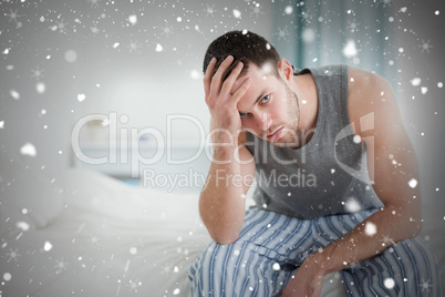 Composite image of tired man sitting on his bed