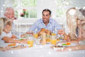 Composite image of happy family at thanksgiving