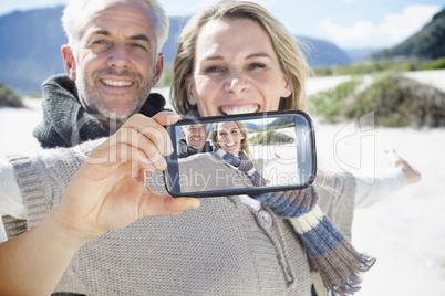 Composite image of hand holding smartphone showing